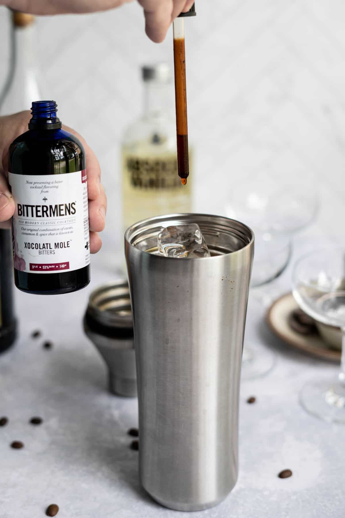 chocolate bitters into cocktail shaker.