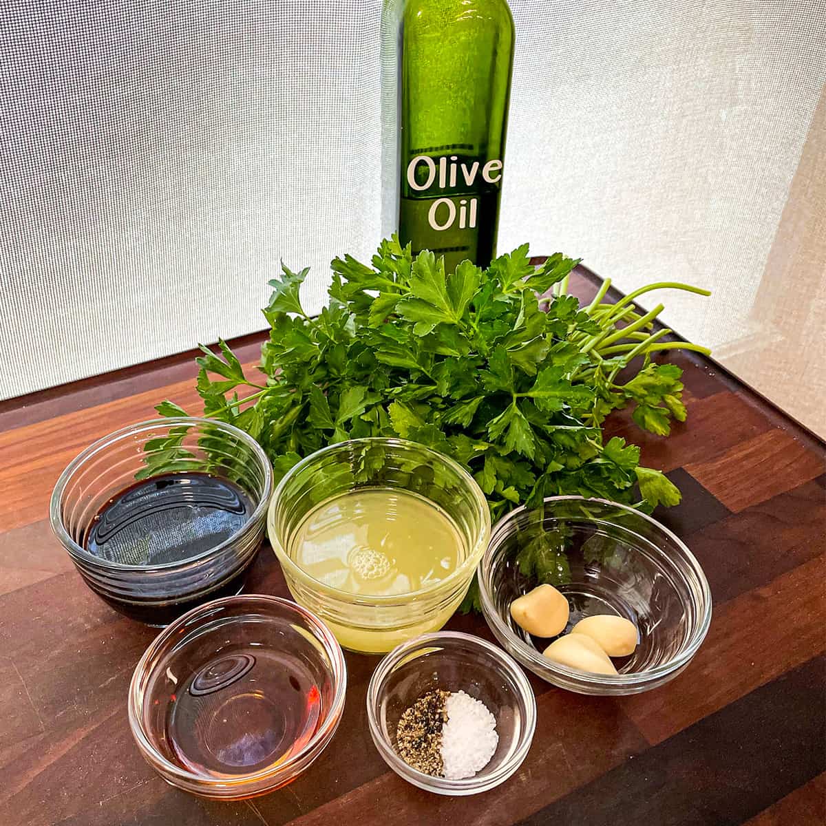prepped ingredients for making a parsley vinaigrette salad dressing.