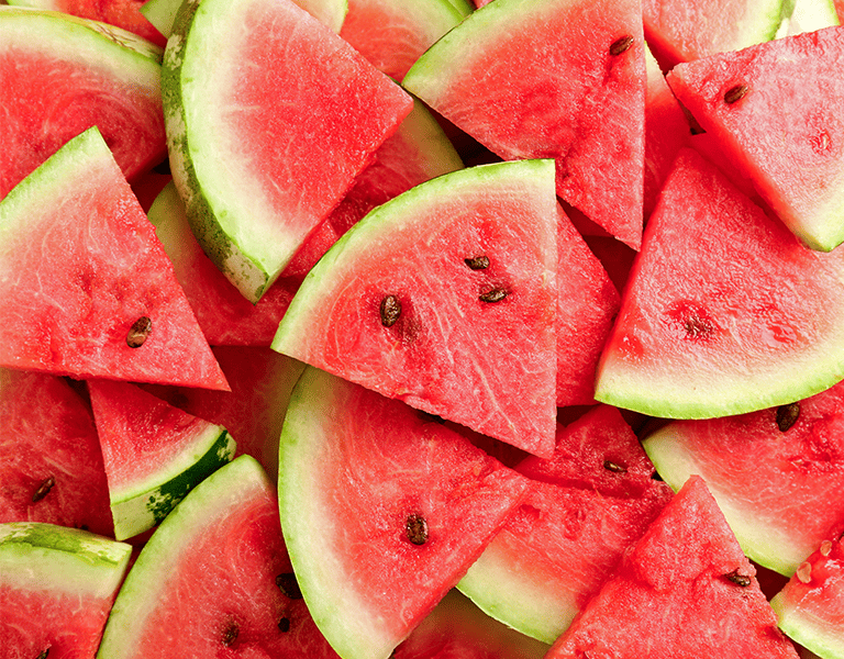 triangular slices of watermelon fill up the frame of a photo