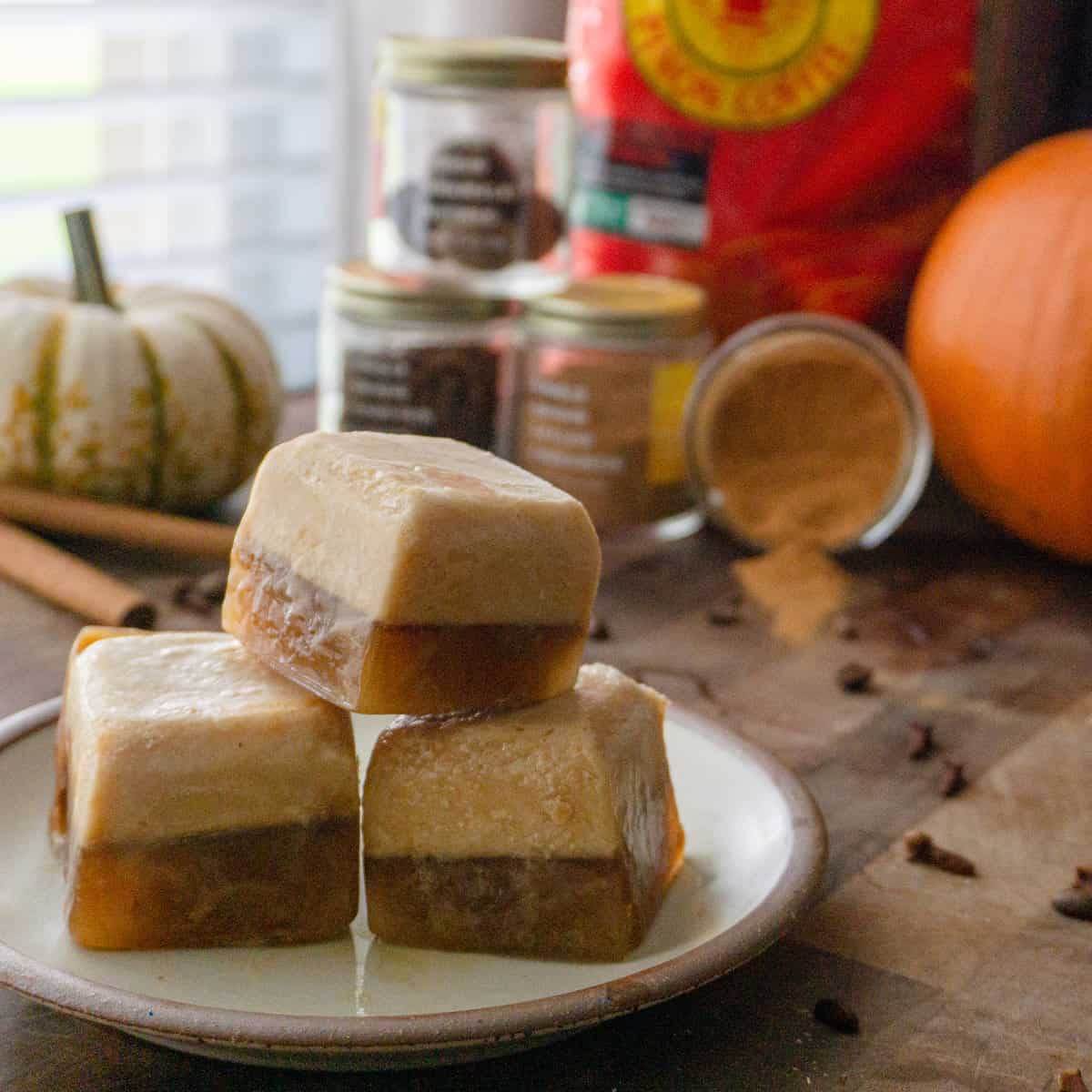 a stack of iced pumpkin spice latte coffee cubes sits on a plate.