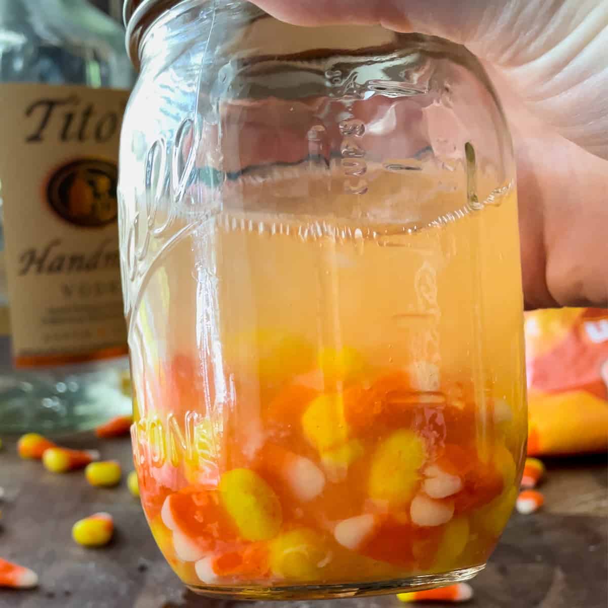 partially dissolved candy corn in vodka