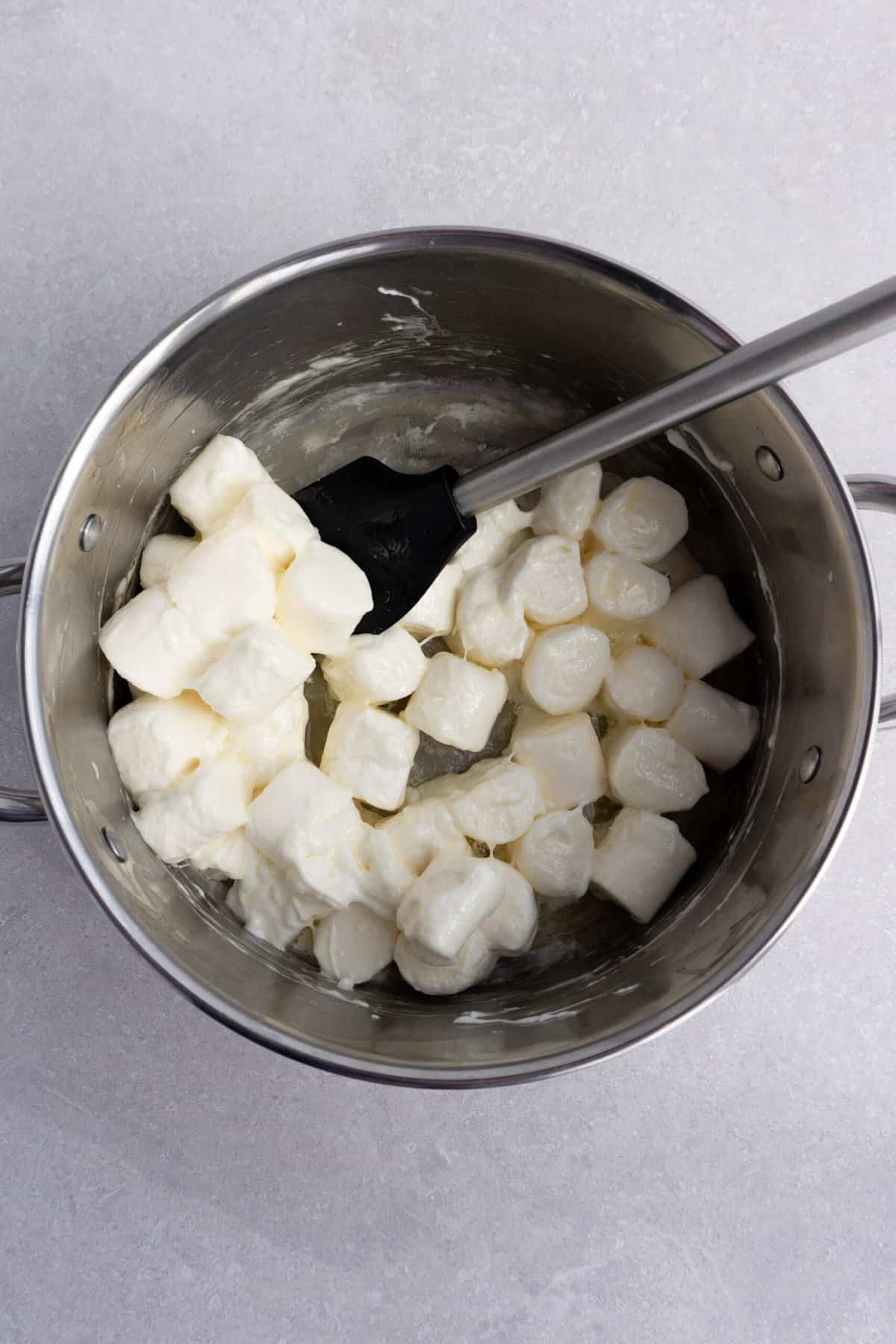 marshmallows melting in a pot in preparation for making copycat Disney rice krispie treats.