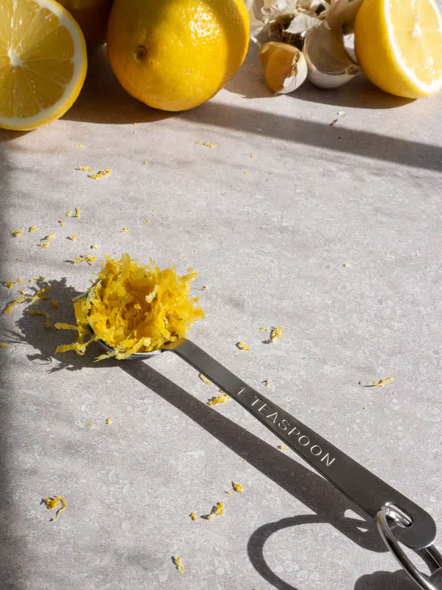 one teaspoon of lemon zest sits on a countertop.