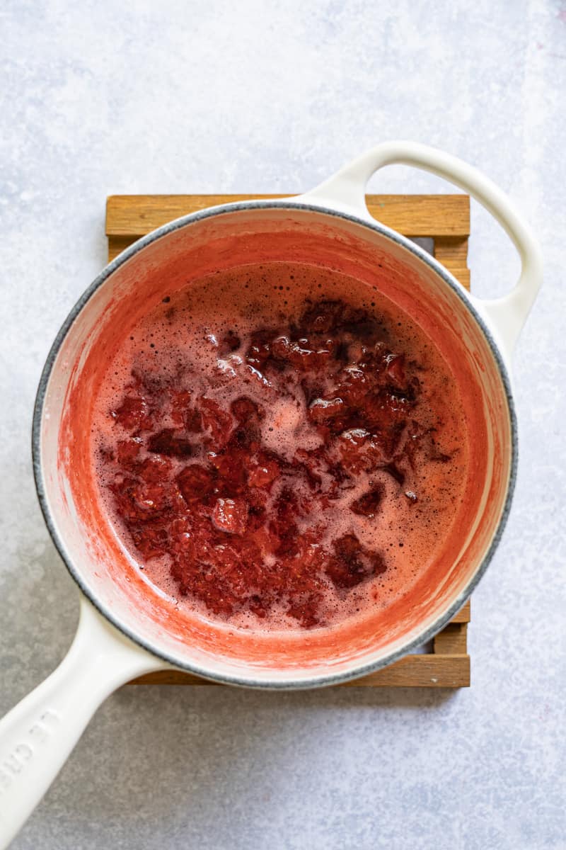 step eight of making homemade strawberry jam without pectin: the jam thickens as it cooks, then cools.