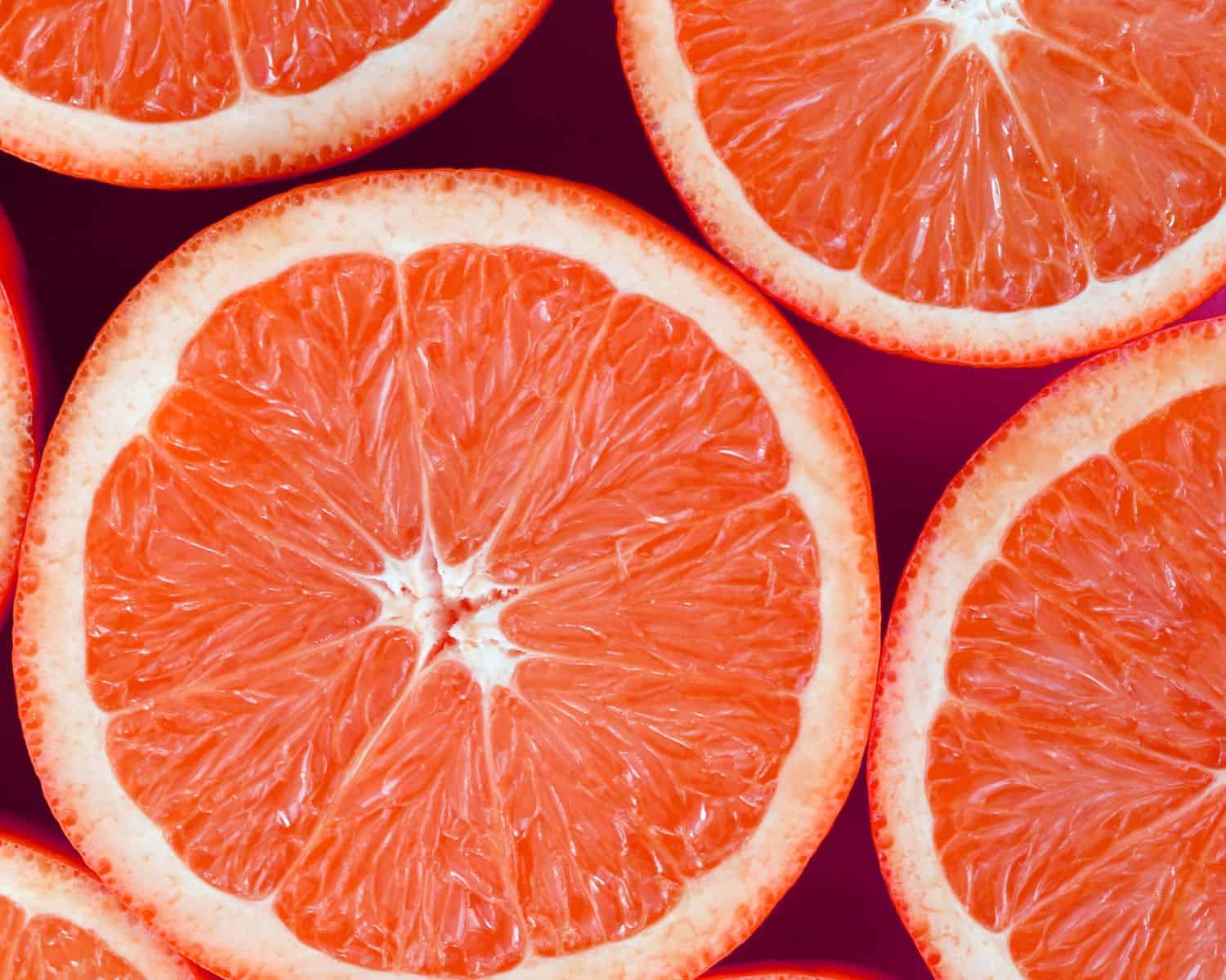 sliced grapefruit fill the frame of a photo.
