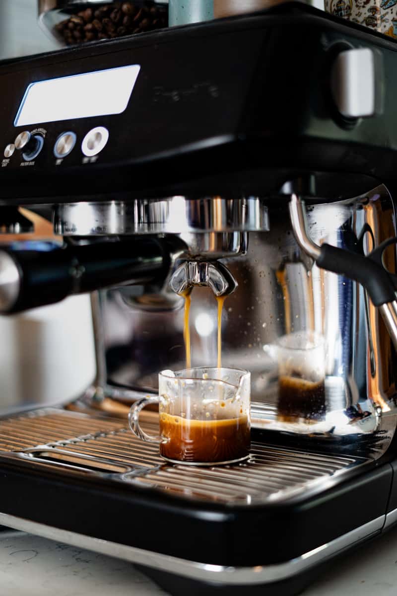Making a double shot of espresso using an espresso machine.