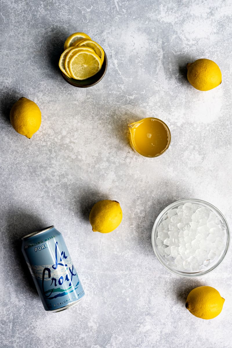 ingredients used to make homemade Italian lemon soda pop sit on a countertop.