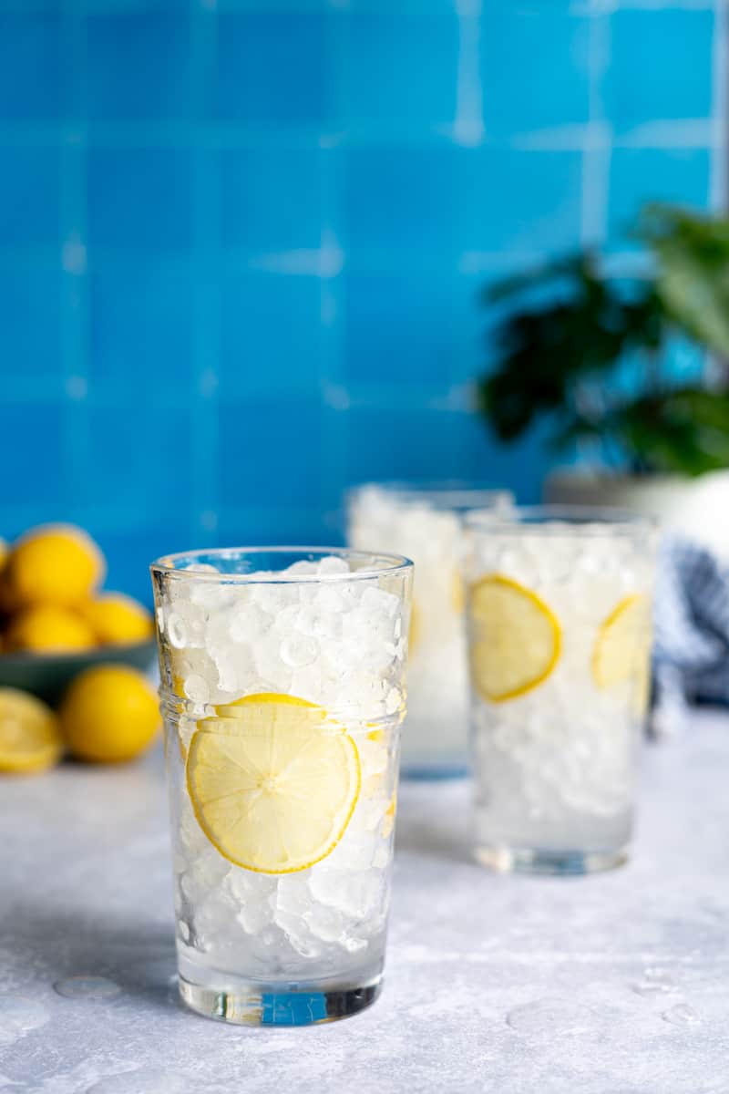Step 3 of making a homemade lemon soda: Fill the remainder of the glass with ice.