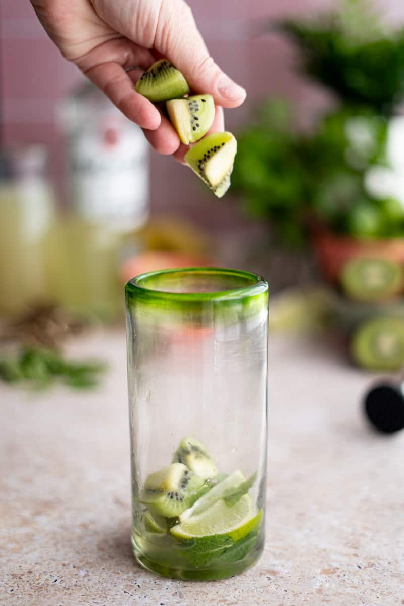 Making a kiwi mojito Step 3: Add kiwis to the cocktail mixing glass.