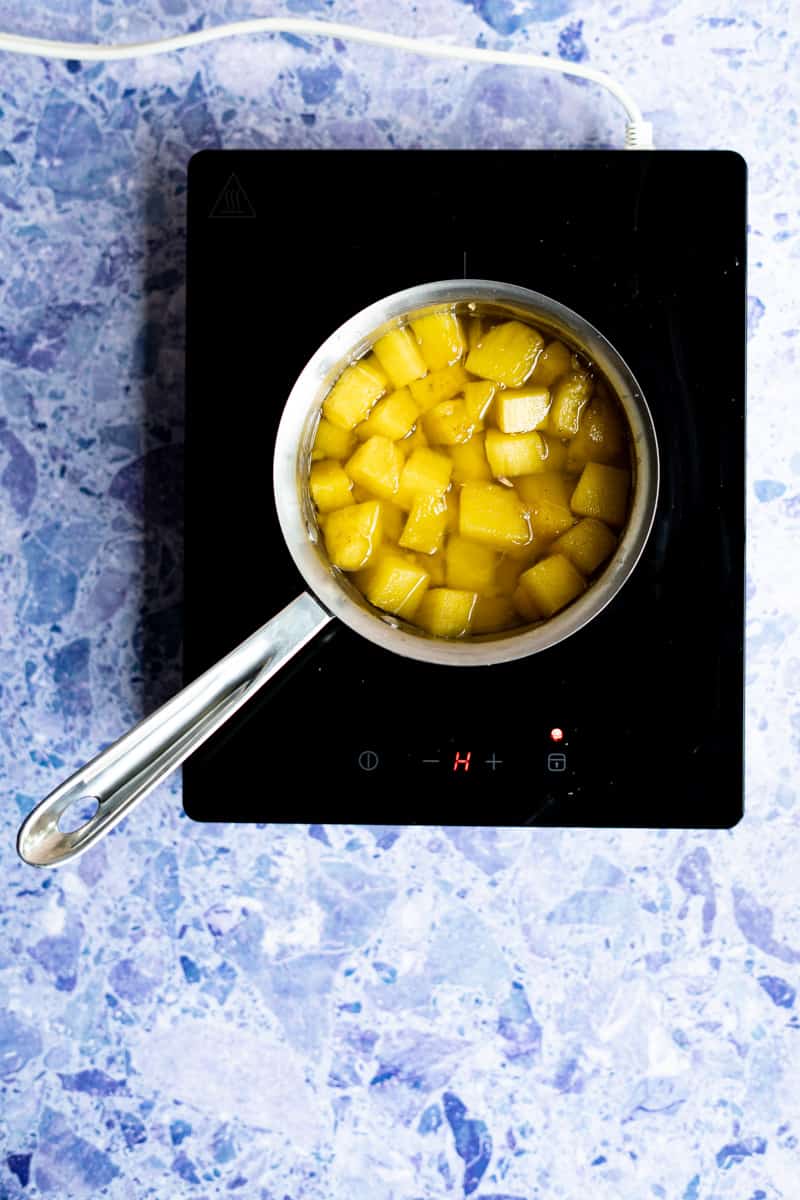 Step 8 in making pineapple simple syrup: allow the syrup to cool slightly.