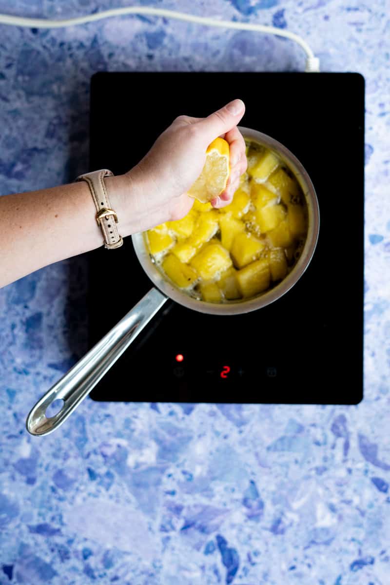step 7 of making pineapple syrup: adding in lemon juice.