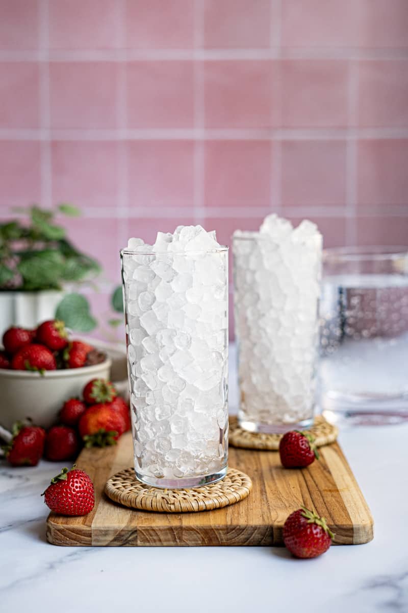 Step 1 of making a strawberry Italian soda: Fill your preferred glass with ice.