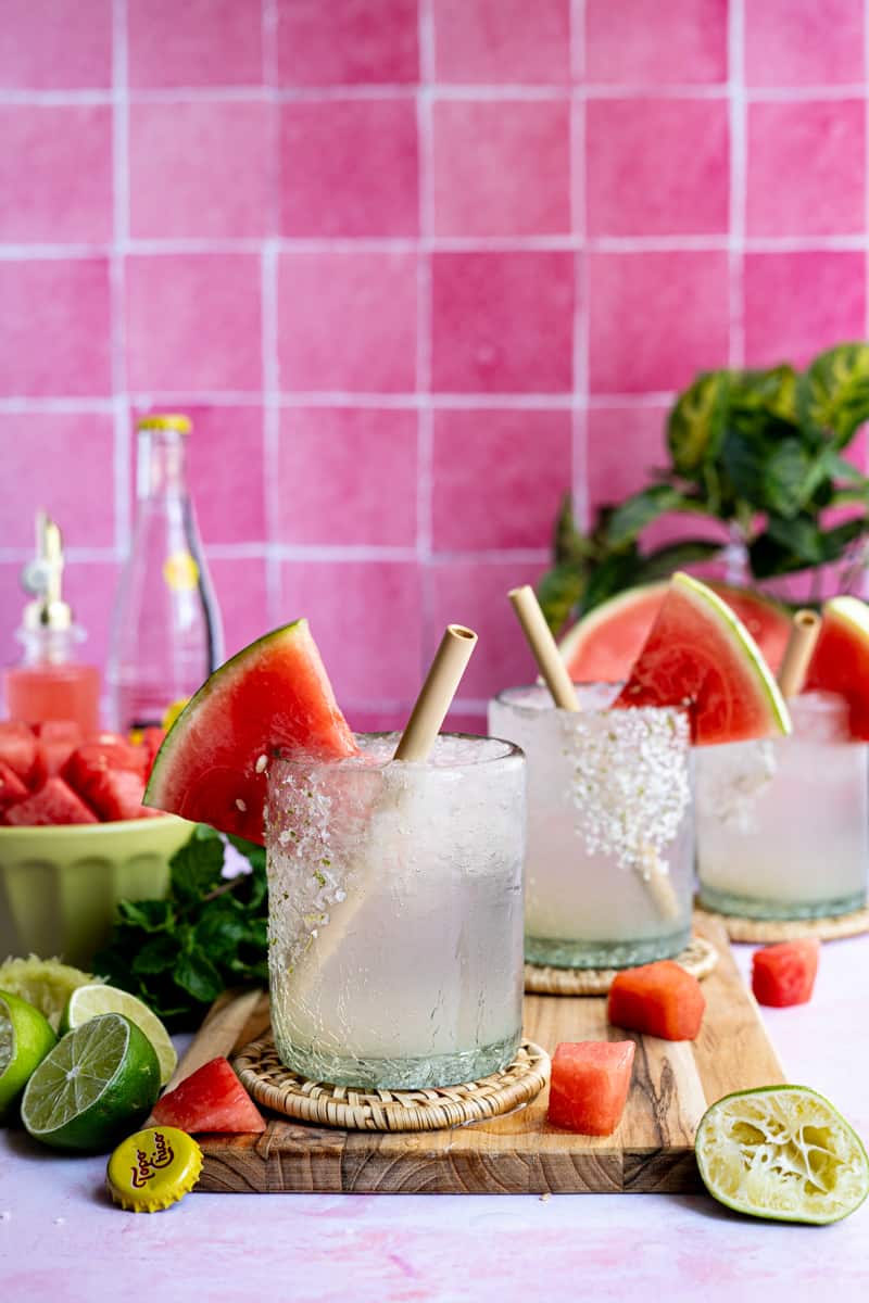 Feature image of watermelon ranch water. Three glasses of watermelon ranch water are sitting on a countertop.