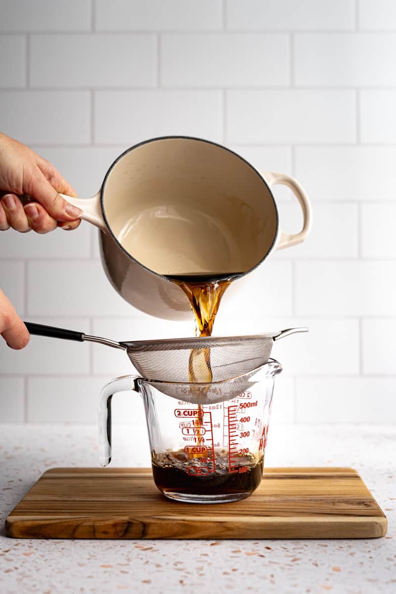 Straining the demerara simple syrup to remove any grainules that didn’t dissolve.