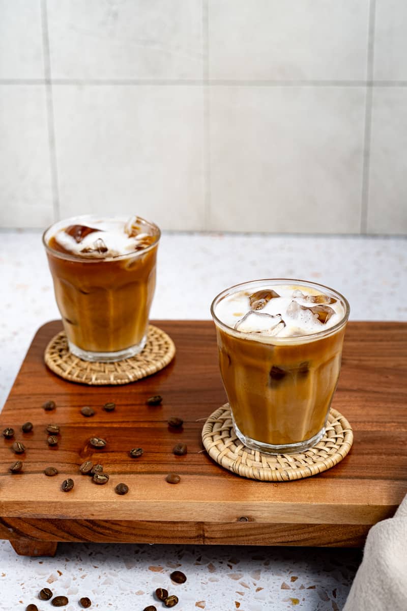 Two iced cortados are ready to be served.