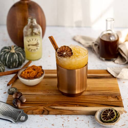 Feature image for a pumpkin spice mule. A glass holding a pumpkin spice mule sits on a countertop ready to be served.
