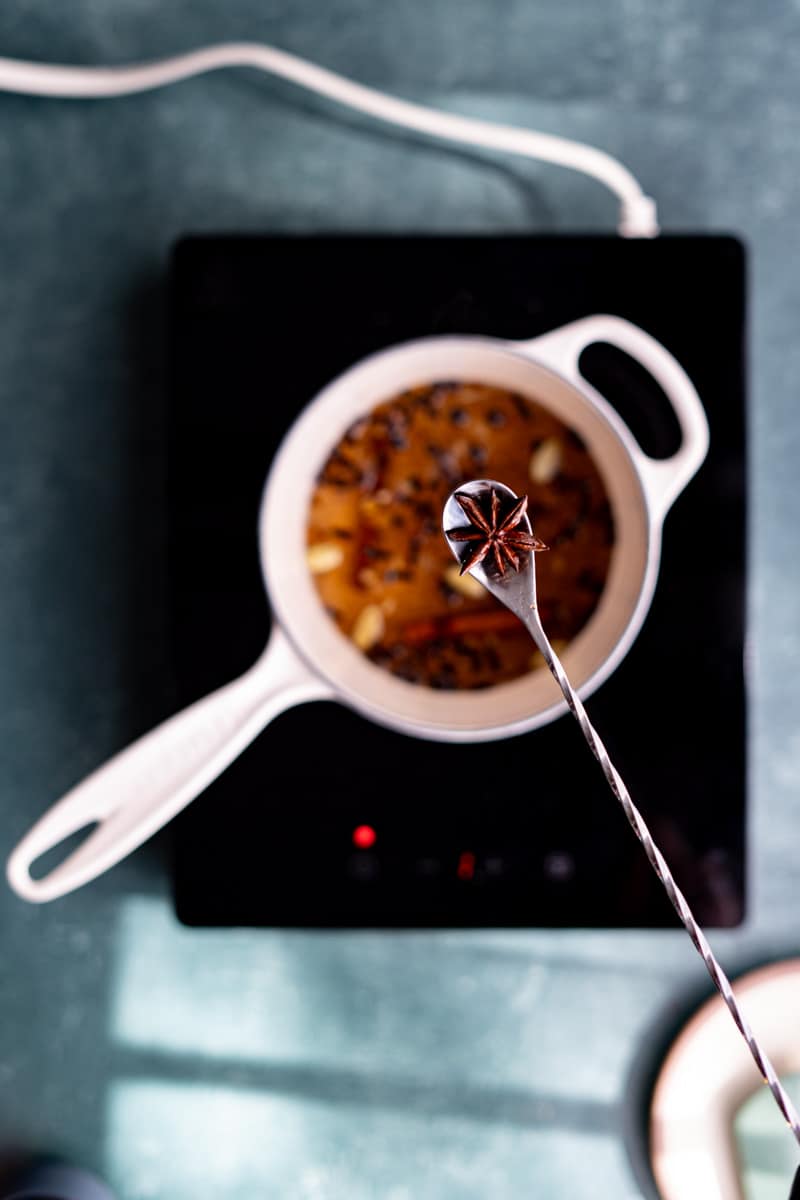 A cocktail mixing spoon shows off a pod of star anise.