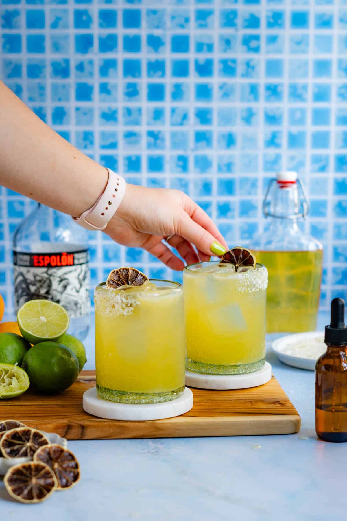 Garnishing a classic silver margarita with a dehydrated lime wheel.