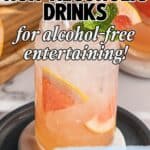 A tall glass filled with a refreshing Italian non-alcoholic drink, garnished with grapefruit, lime, and mint, sits on a plate. Overlaid text highlights Italian Non Alcoholic Drinks and alcohol-free entertaining.