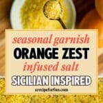 A spoon with orange zest-infused salt hovers over a bowl of the same salt, surrounded by fresh oranges. Text overlay reads: Seasonal garnish: Orange Zest Infused Salt. Sicilian Inspired. arecipeforfun.com.