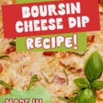 A close-up of a cheesy dip garnished with fresh basil, overlaid with colorful text: Quick + Easy Boursin Cheese Dip Recipe! Made in only 30 minutes. Website name appears at the top.